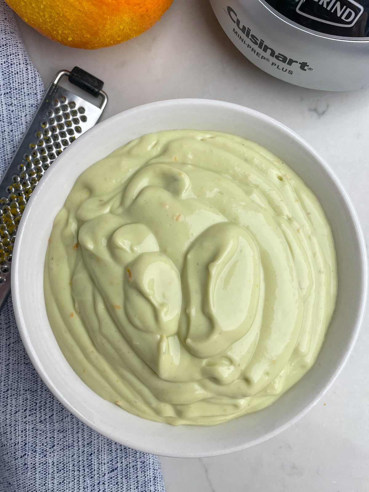 creamy avocado dressing in a white bowl