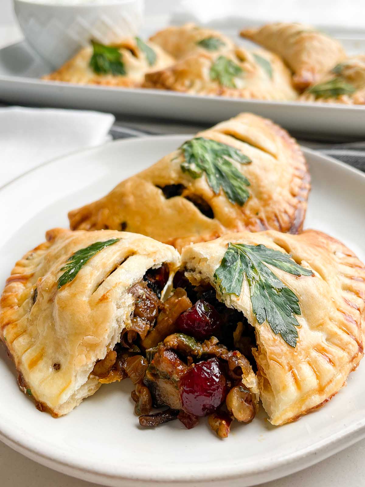 baked vegetarian empanadas on a white plate