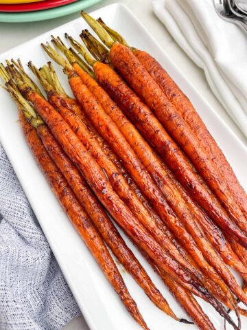 maple balsamic glazed carrots on a white platter.