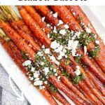 maple balsamic glazed carrots topped with feta and chimichurri on a white platter.