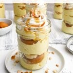 banana pudding cup in a mason jar on a white plate