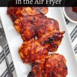 air fryer bbq chicken thighs on a white platter next to bowl of bbq sauce