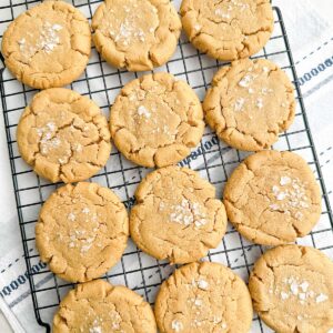 Browned butter peanut butter cookies on a wire baking rack.