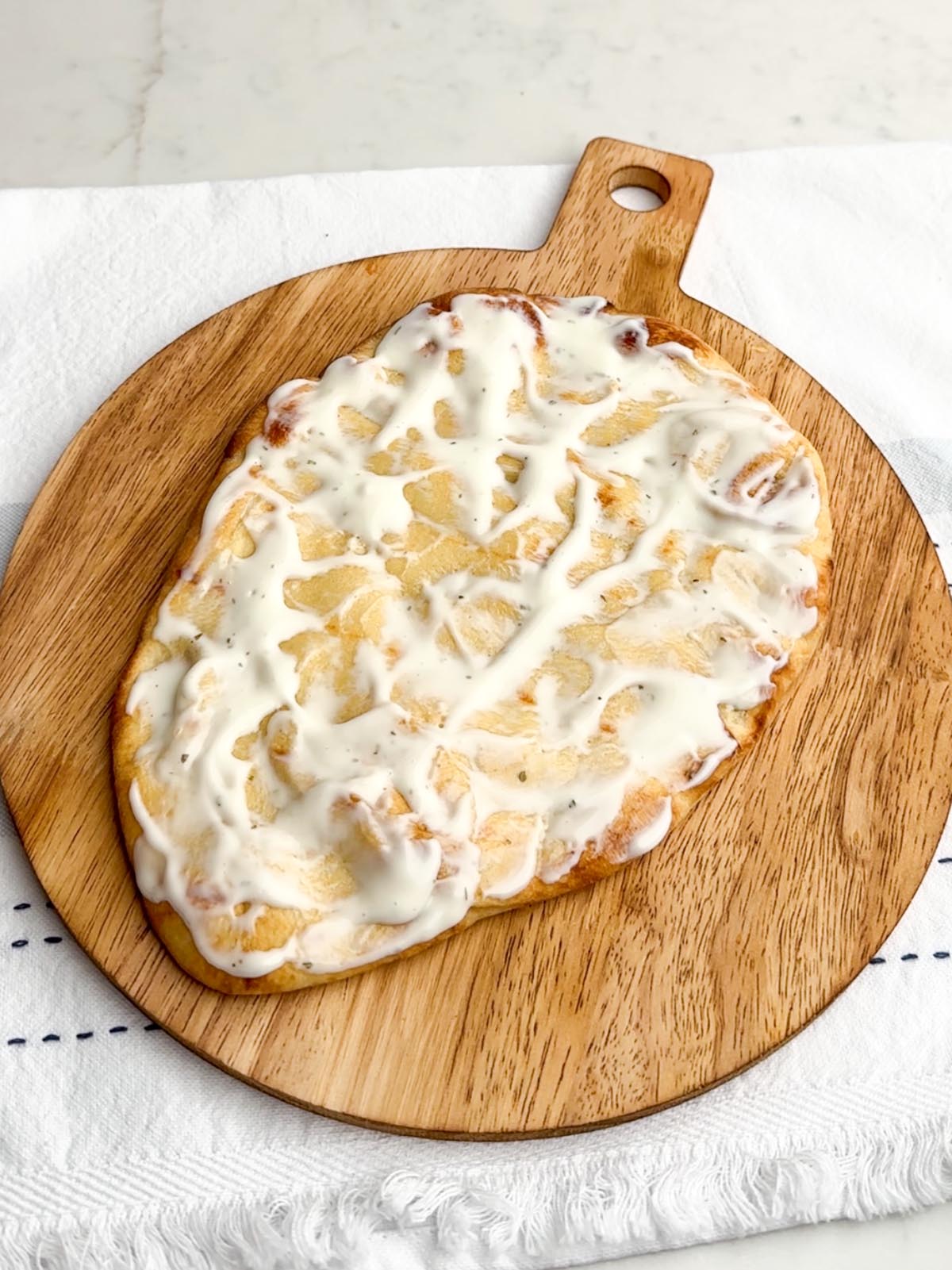 naan topped with blue cheese dressing