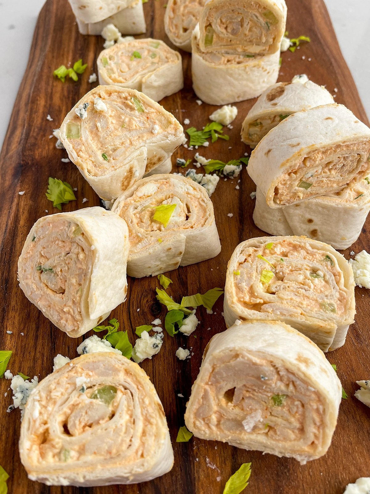 Buffalo Chicken Pinwheels on a wooden cutting board