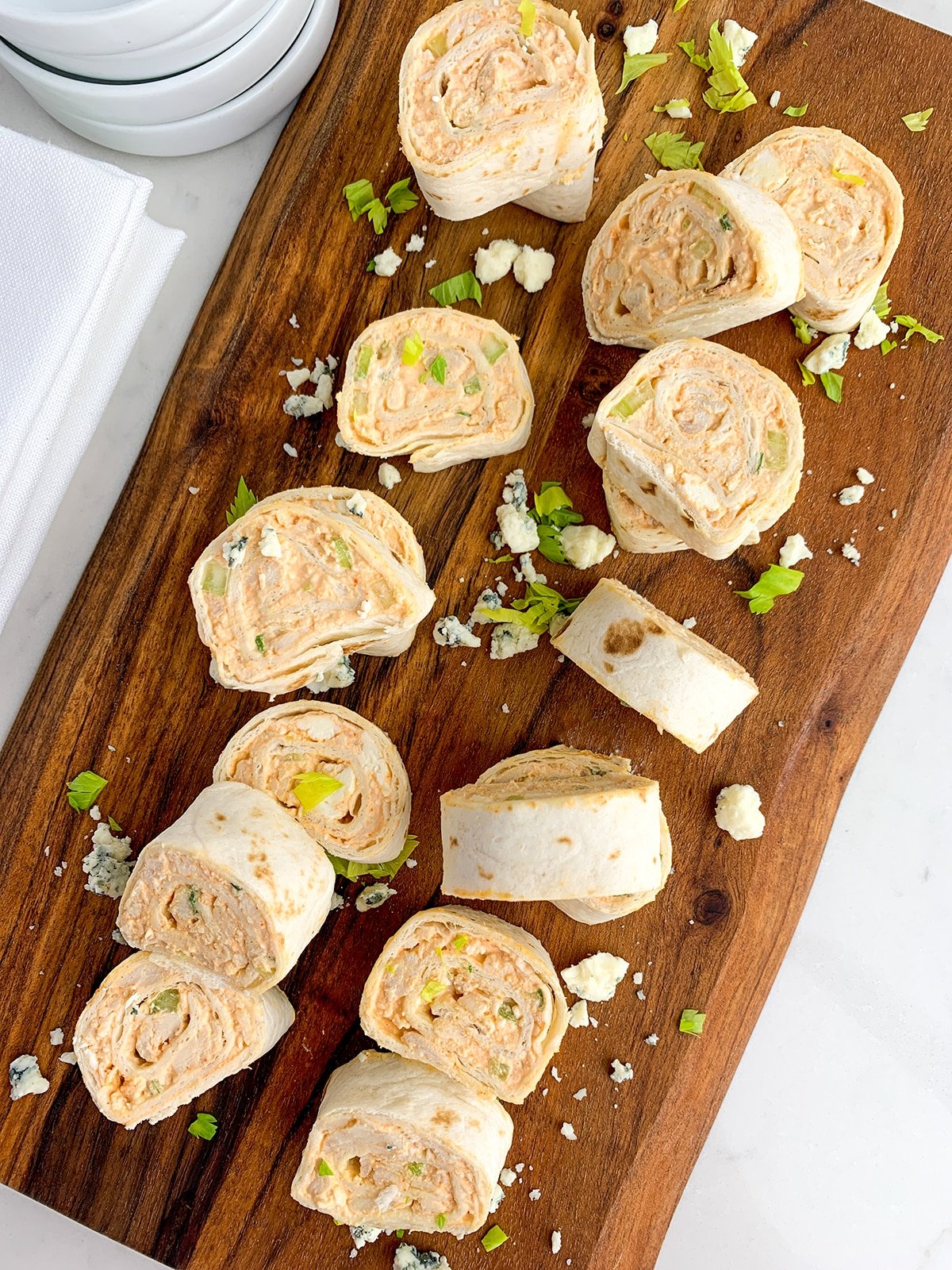 Buffalo Chicken Pinwheels on a wooden cutting board