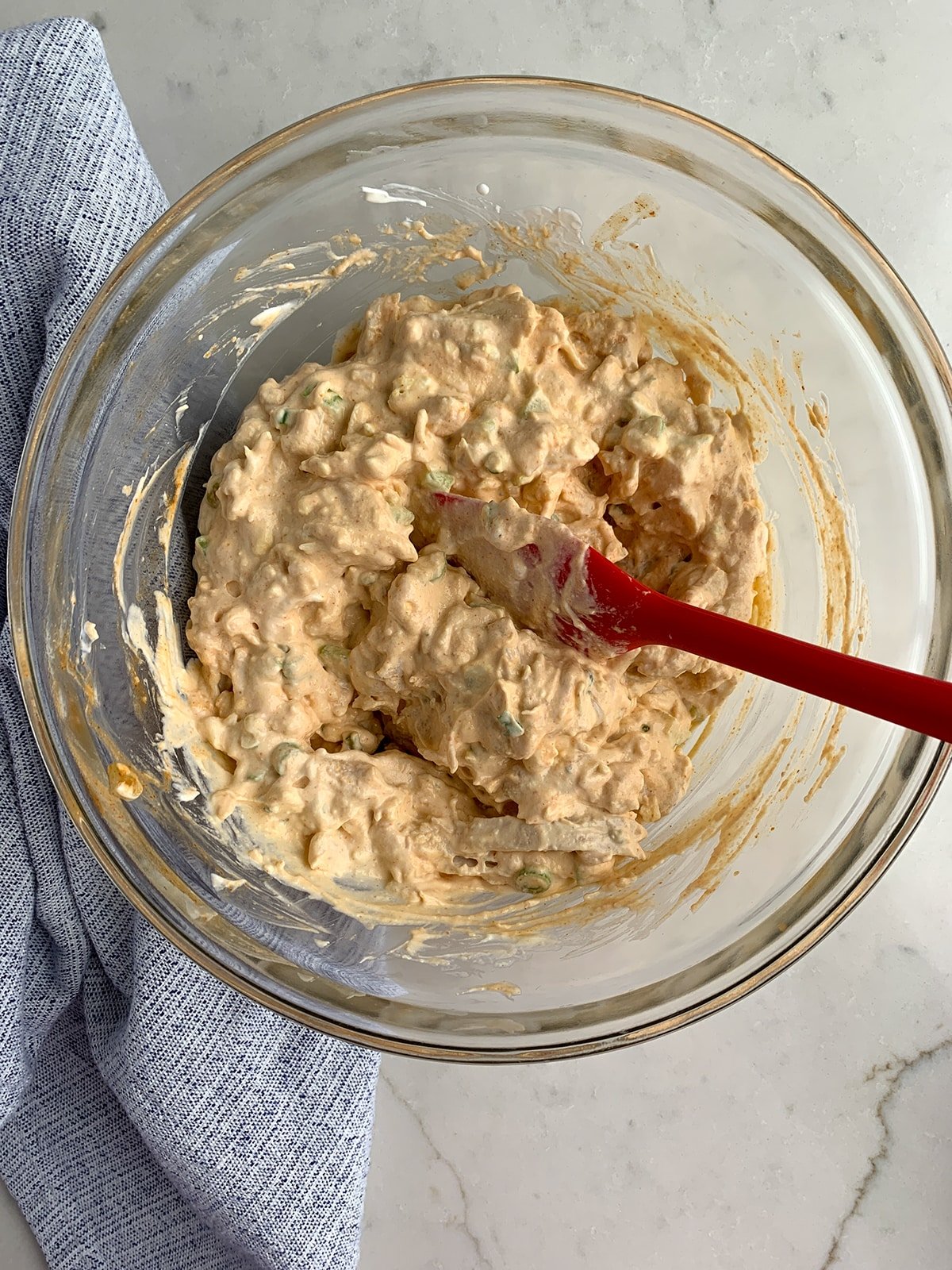 Buffalo Chicken Pinwheel ingredients mixed together in a clear bowl