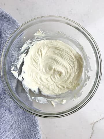 cream cheese, sour cream and Dijon mixed together in a clear bowl. 