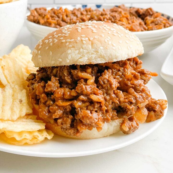chicken gumbo sloppy joe on a white plate with potato chips