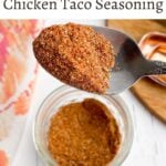 spoon full of chicken taco seasoning over a mason jar of seasoning