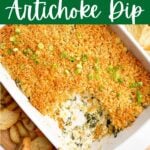 crab spinach artichoke dip in white baking dish with pita chips and crostini