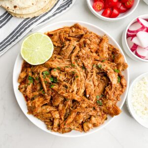 shredded salsa chicken in a white bowl