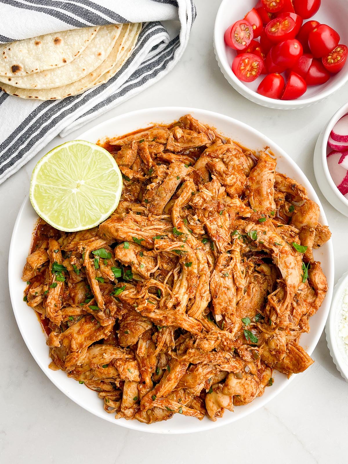 shredded salsa chicken in a white bowl