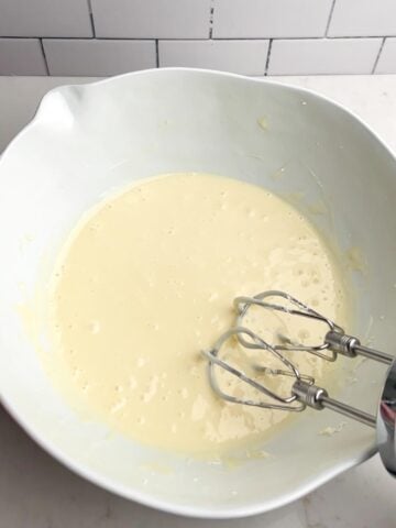 cream cheese mixture in white mixing bowl.