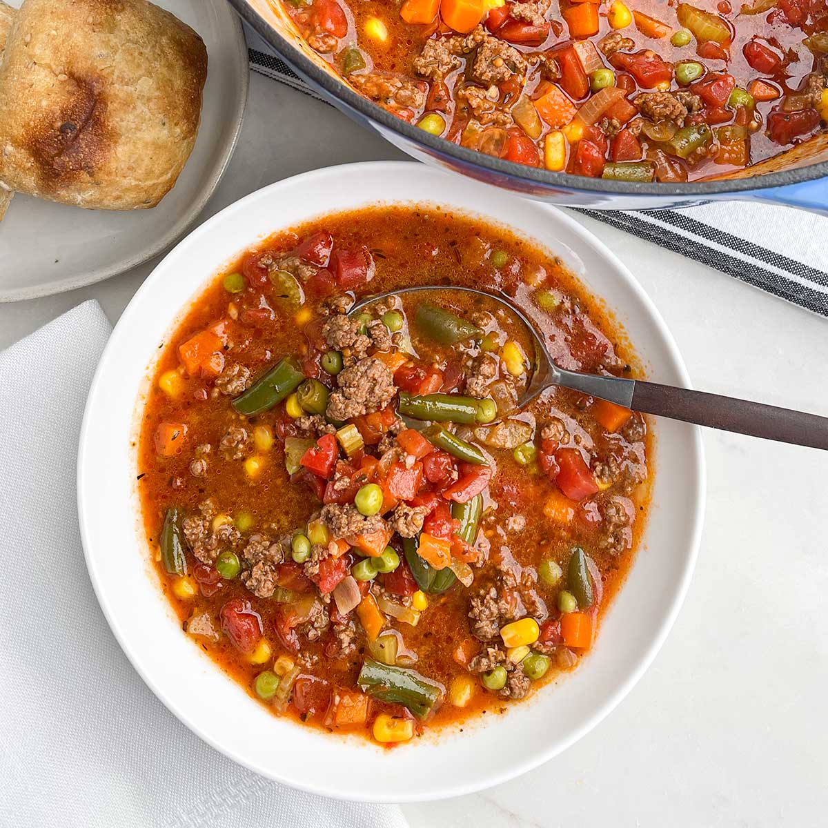 ground beef vegetable soup recipe in a white bowl.