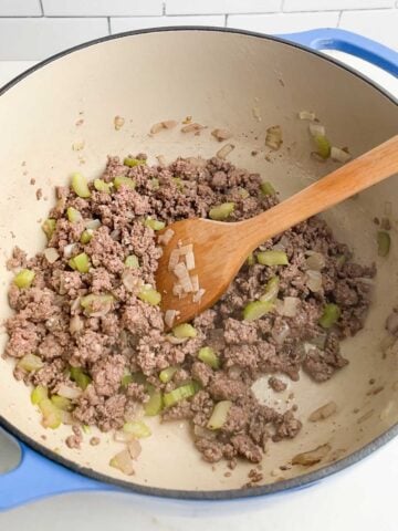 browned ground beef, onions, and celery in a Dutch oven.