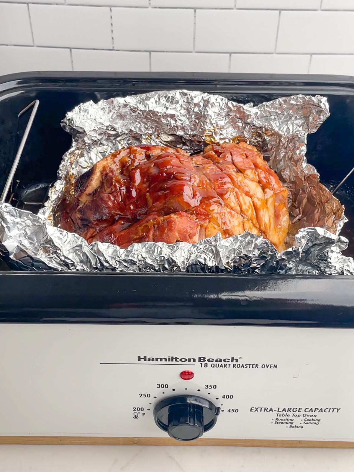 roaster oven ham in foil in roaster oven.