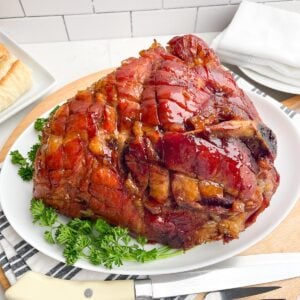 glazed roaster oven ham on a white platter