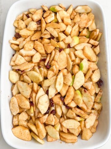 apple mixture in a white baking dish.