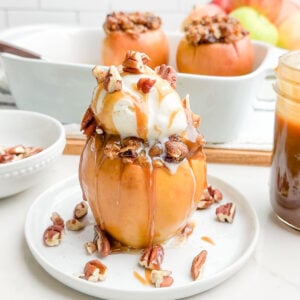 baked cinnamon apple topped with ice cream and caramel sauce