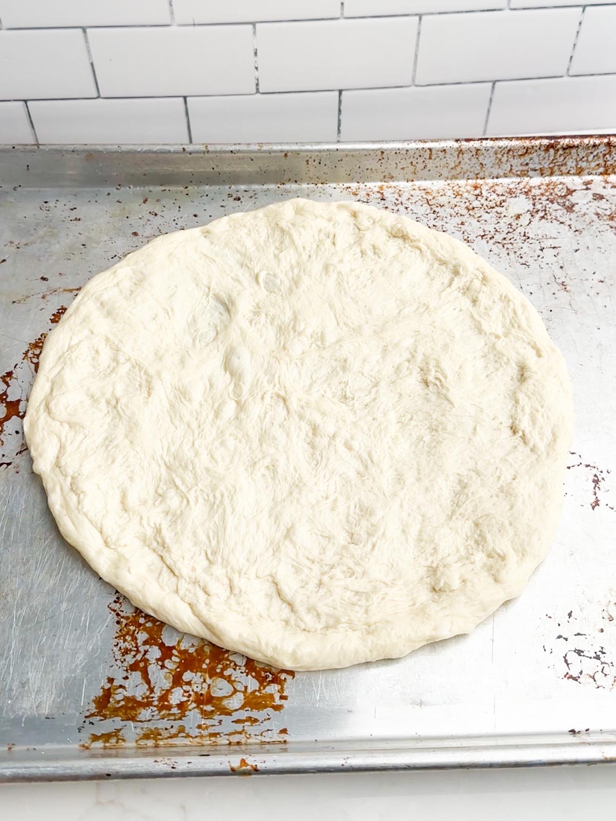 pizza dough on a baking sheet