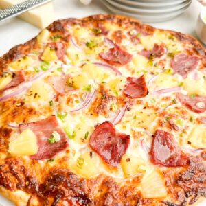 baked pineapple pizza on white countertop