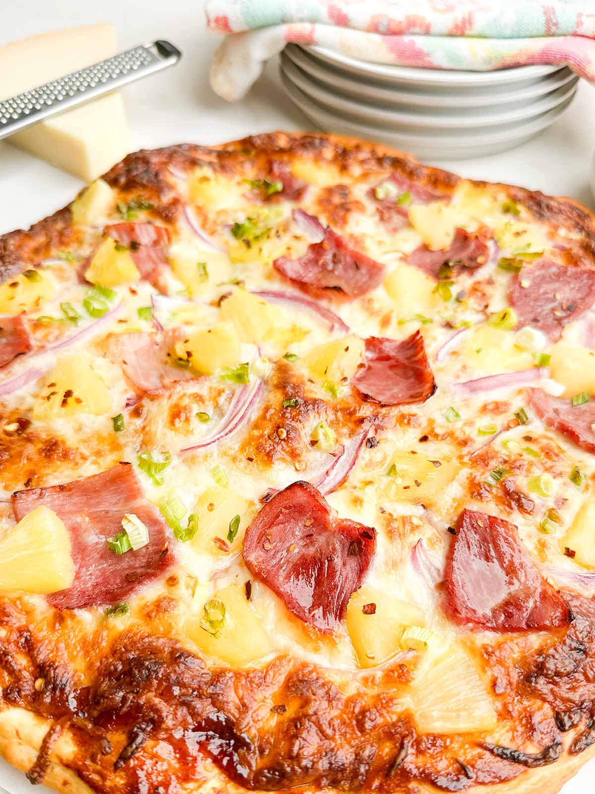 baked pineapple pizza on white countertop