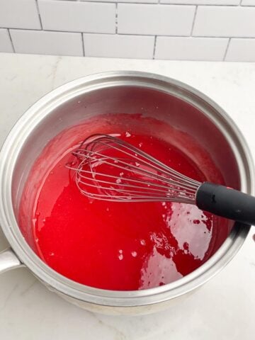 strawberry jello mixture in saucepan.