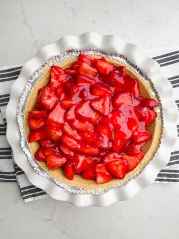 strawberry jello pie in white pie plate.
