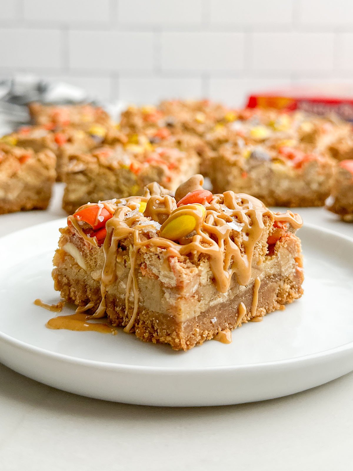 A Nutter Butter bar drizzled with peanut butter on a white plate.