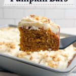 spatula lifting a pumpkin bar with the pan of bars in the background