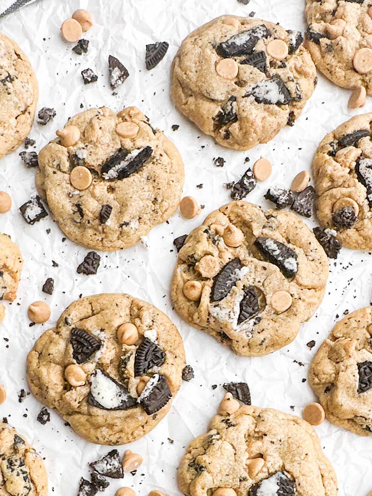 Peanut butter Oreo cookies on white parchment paper.