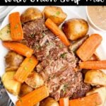 pot roast with onion soup mix, potatoes, and carrots on a white platter