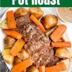 pot roast with onion soup mix, potatoes, and carrots on a white platter