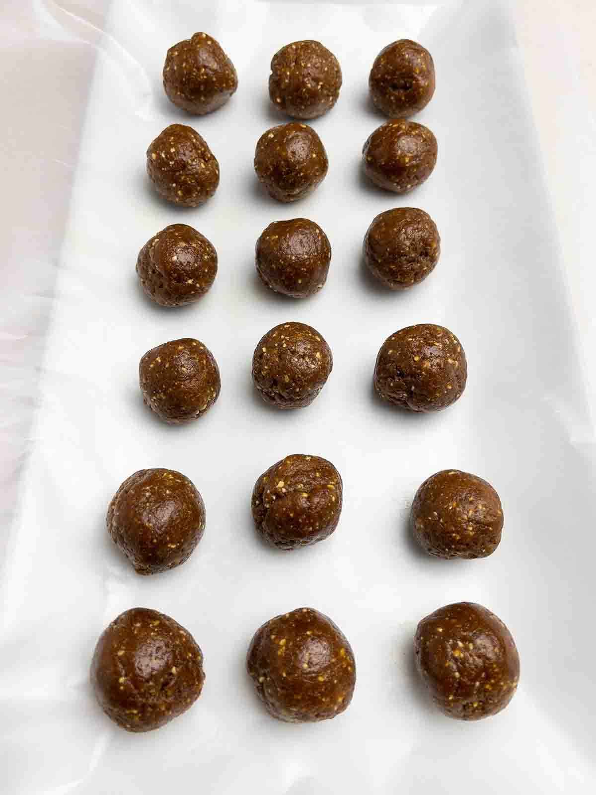 pumpkin gingerbread truffle balls on wax paper on a white platter