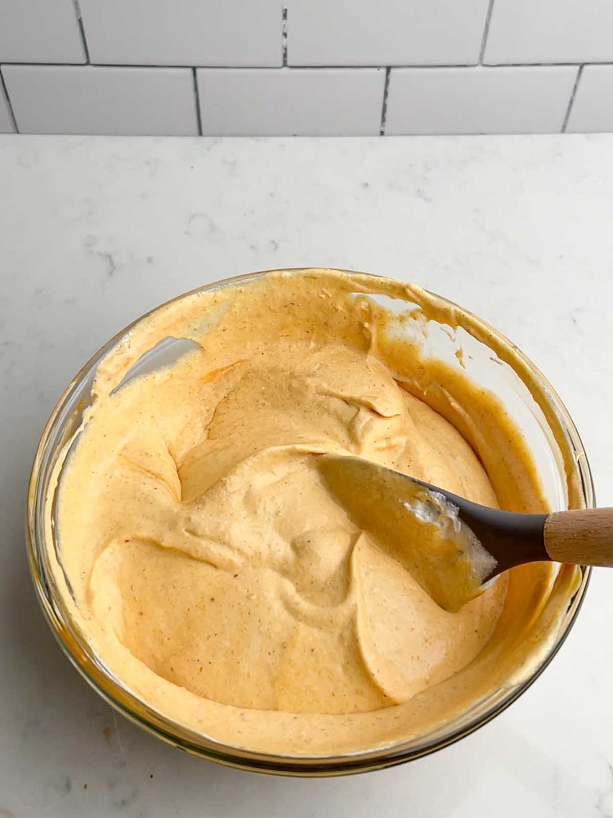 pumpkin pudding mixture in a clear bowl