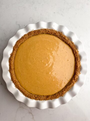 unbaked pumpkin pie in graham cracker crust.