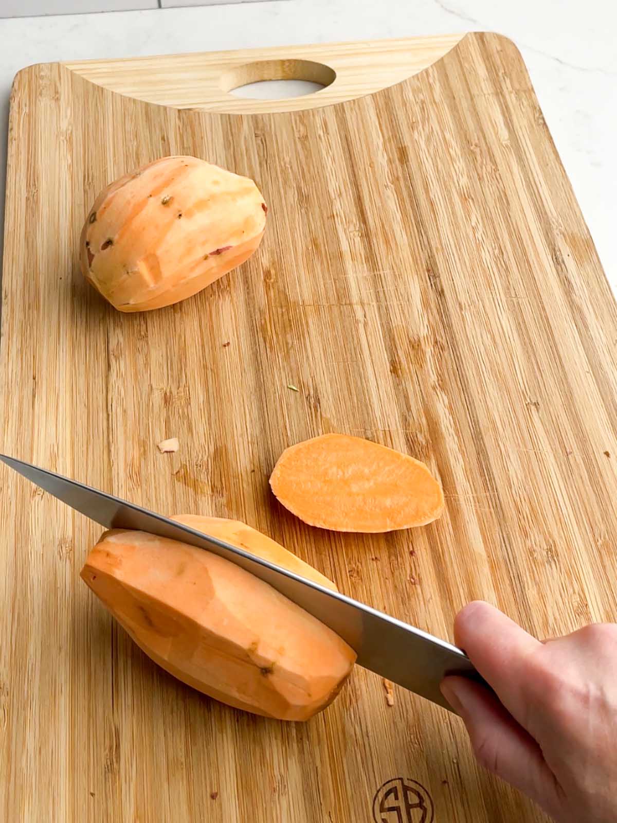 knife cutting into a sweet potato