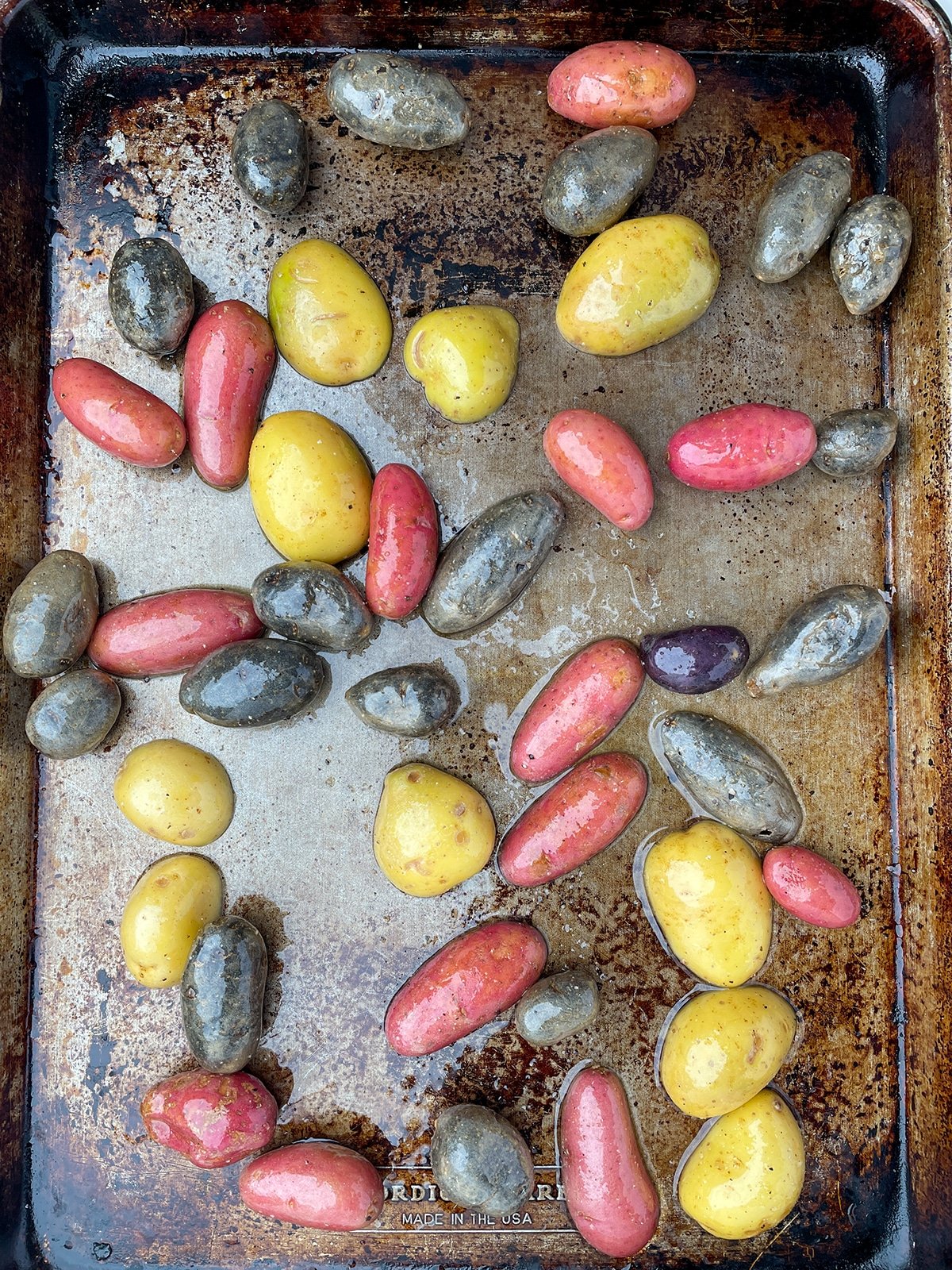 Cut potatoes on a sheet pan with olive oil