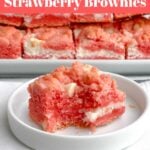 one Strawberry Brownie ona white plate in front of a platter of strawberry brownies