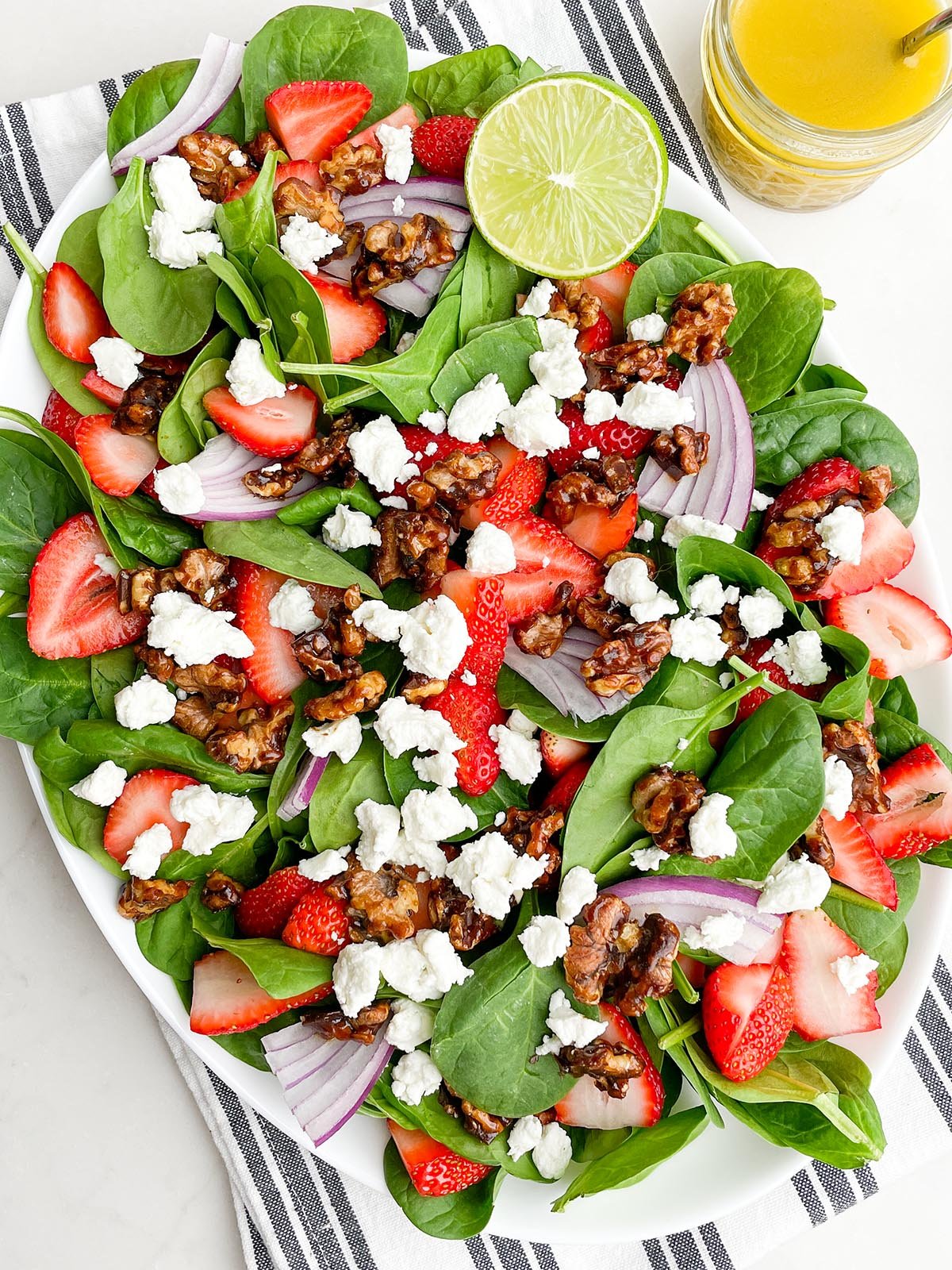 strawberry goat cheese salad on a white platter