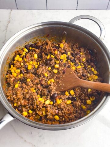 taco meat with black beans and corn in skillet.