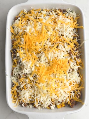 shredded cheese on taco dip in casserole.