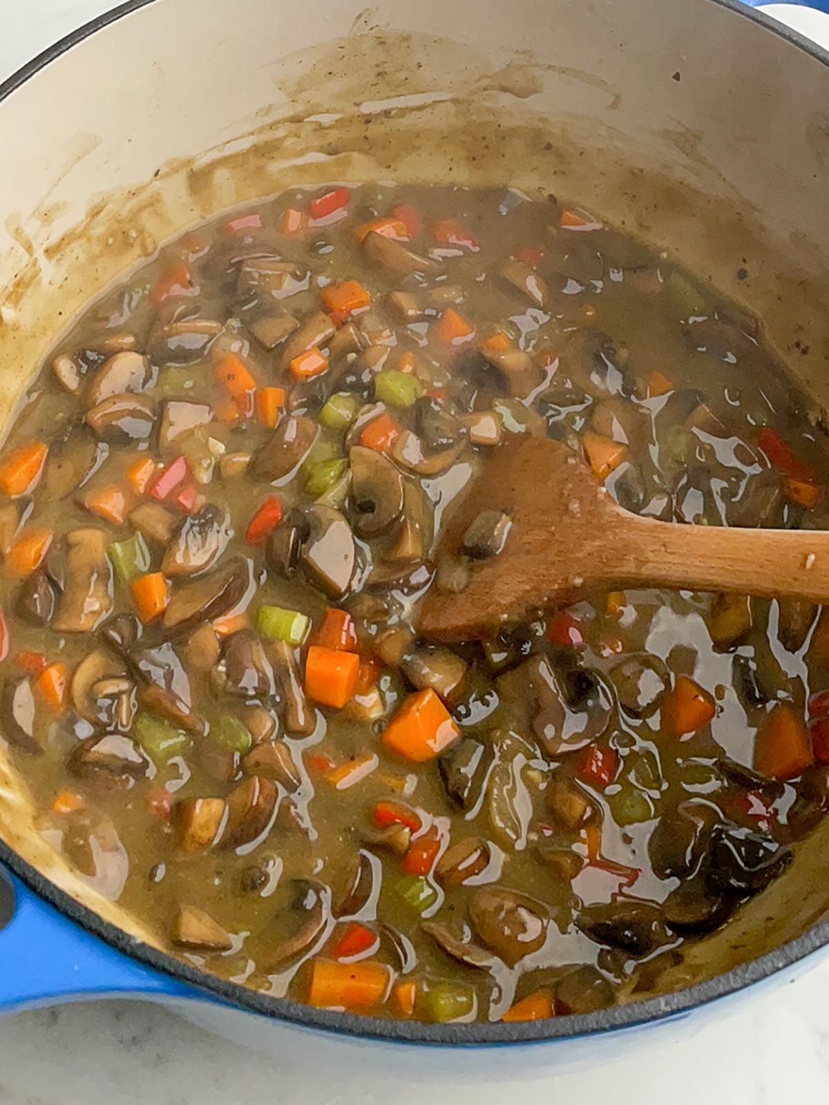 vegetarian pot pie filling in a dutch oven