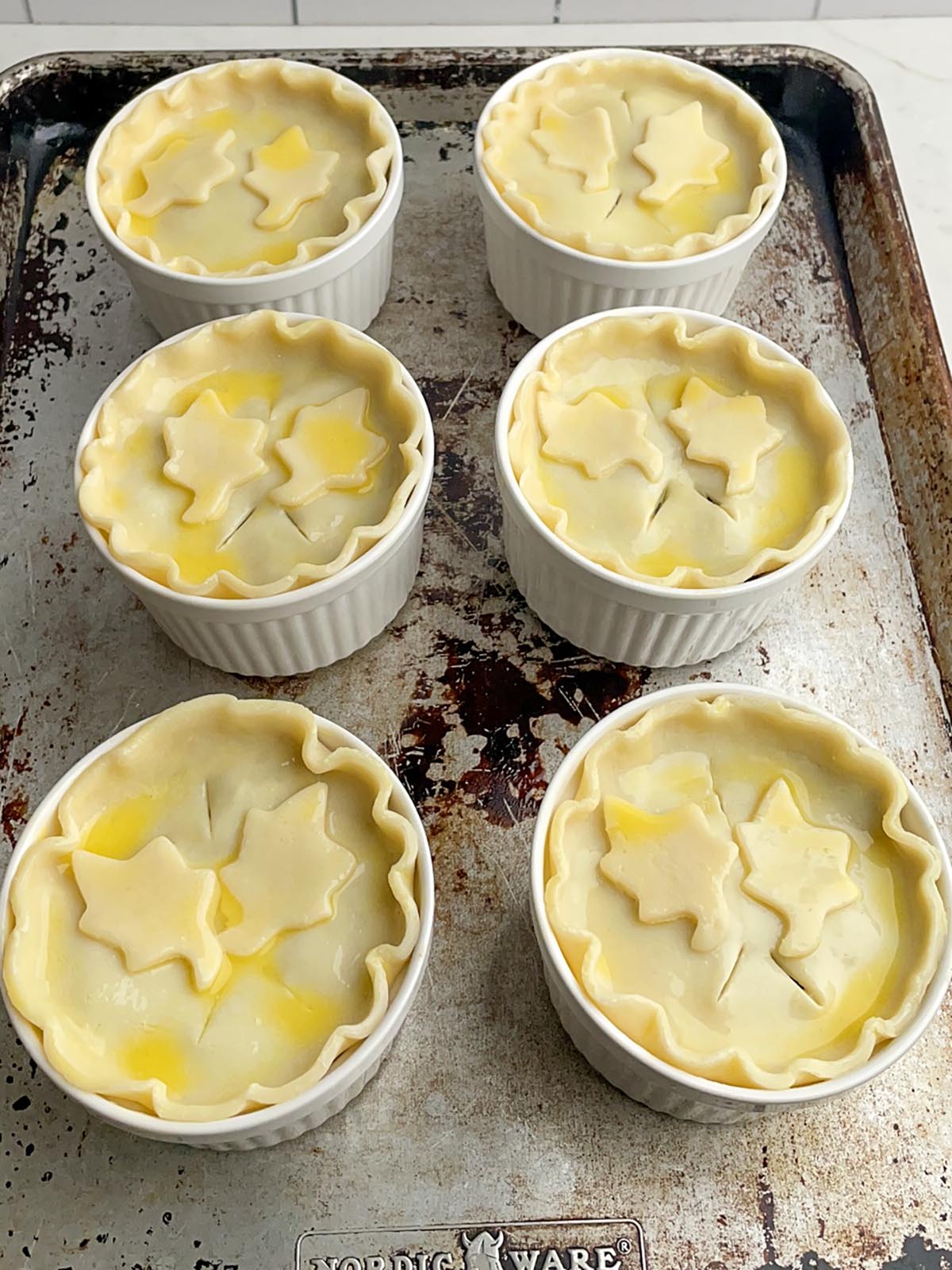 unbaked pot pies on a baking sheet