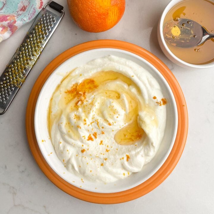 bowl of whipped ricotta topped with honey and orange zest